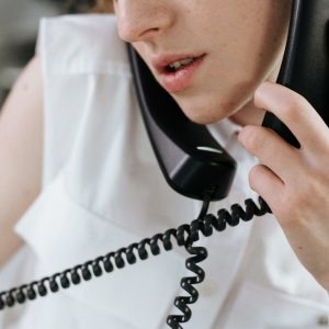 Close-up of a woman talking on a phone in an office setting.